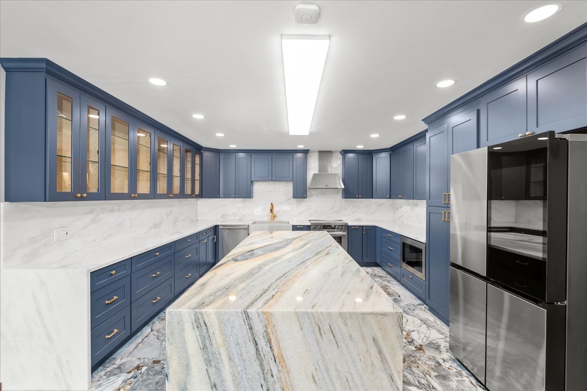 Elegant blue kitchen with marble countertops