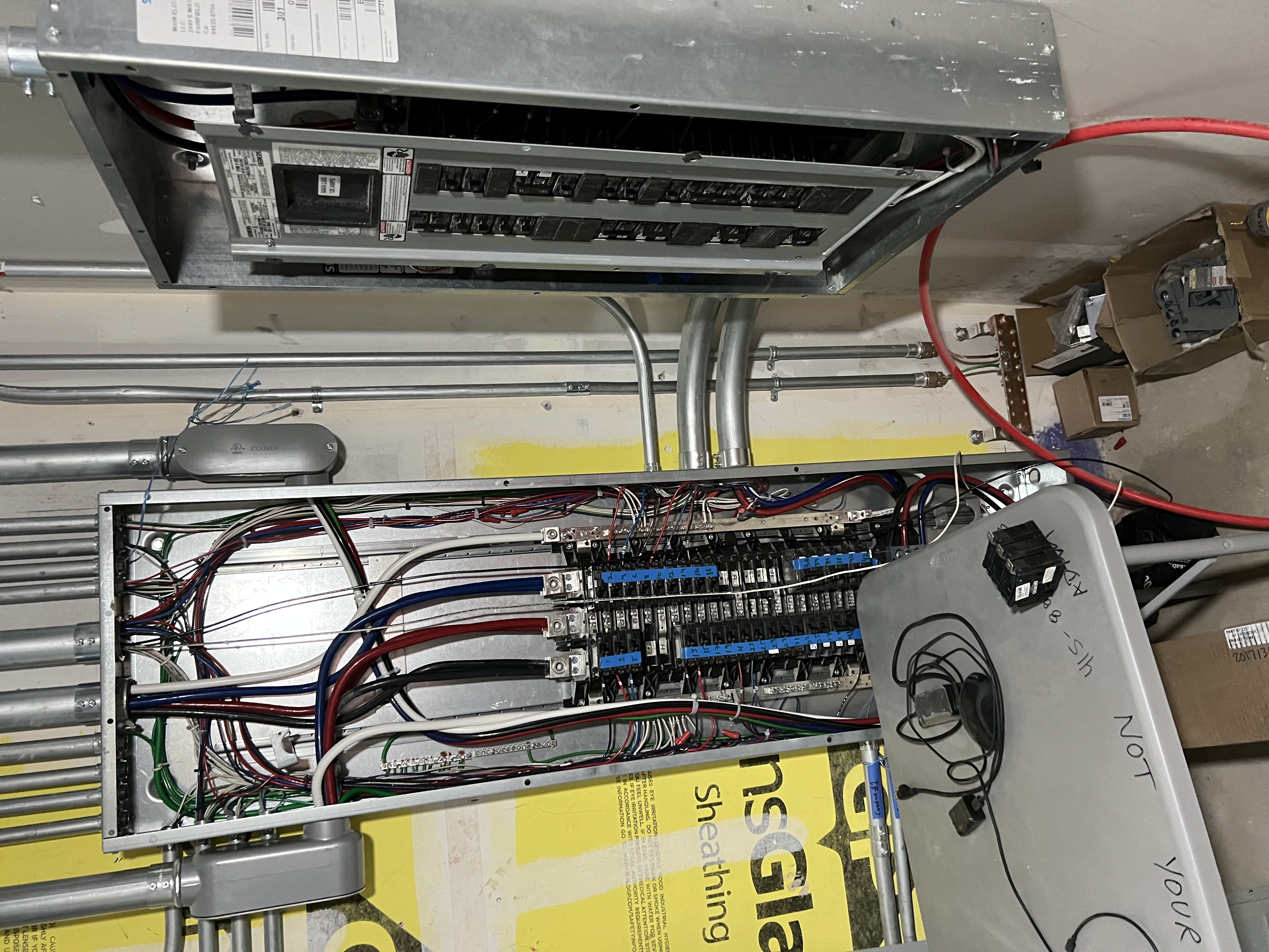Commercial-grade electrical subpanel with organized circuit breaker layout and meticulous wire management