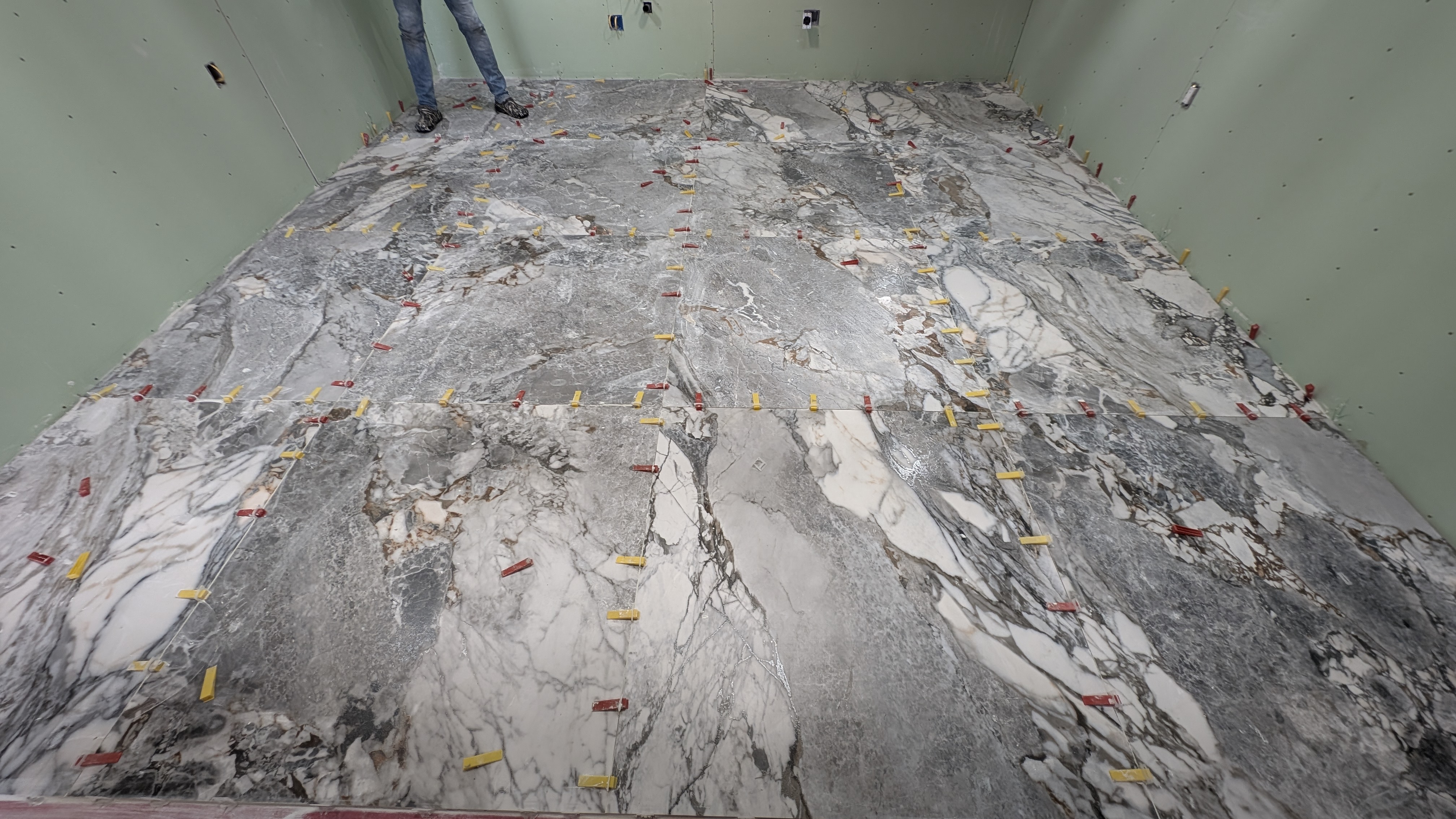 Ultra large format 4ft x 4ft Italian porcelain tile expertly laid for a kitchen floor